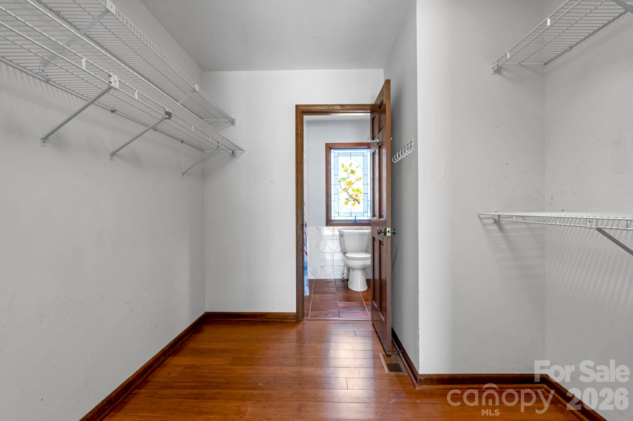 3104 Cove Loop Road Hendersonville, NC 28739 - Photo 28 of 40 a view of a hallway with wooden floor and a bathroom