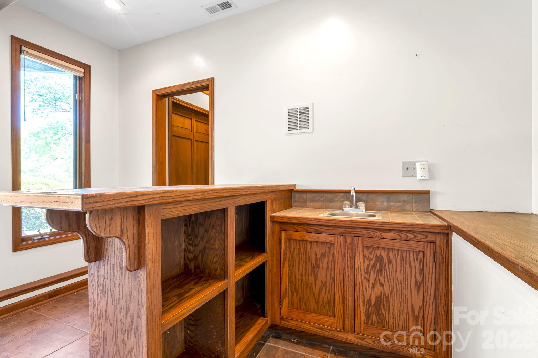 3104 Cove Loop Road Hendersonville, NC 28739 - Photo 32 of 40 a bathroom with a sink and a mirror