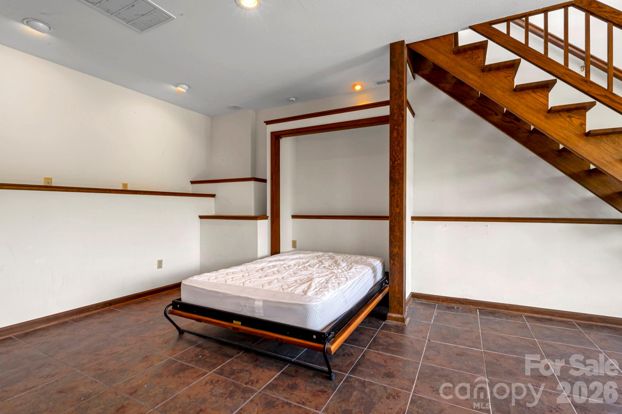 3104 Cove Loop Road Hendersonville, NC 28739 - Photo 34 of 40 a bedroom with a bed and window