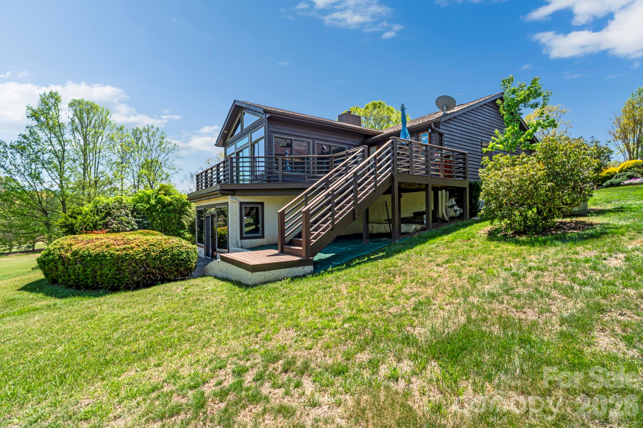 3104 Cove Loop Road Hendersonville, NC 28739 - Photo 40 of 40 a view of a house with backyard and sitting area