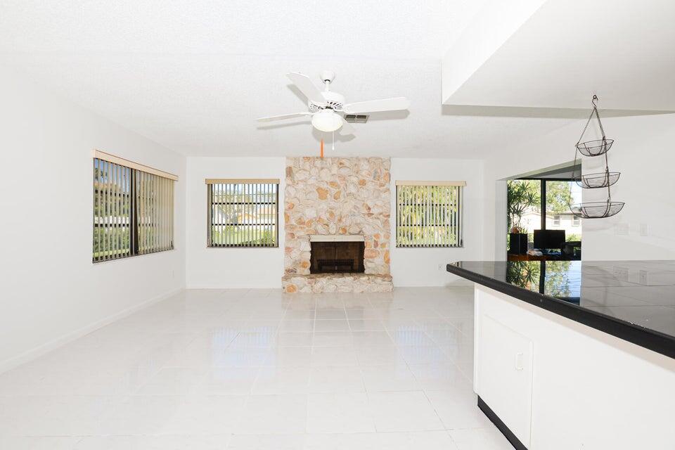 1117 Southeast Mendoza Avenue Port St. Lucie, FL 34952 - Photo 11 of 24 a view of an empty room with a fireplace and a window