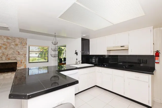 a kitchen with stainless steel appliances a sink and a microwave