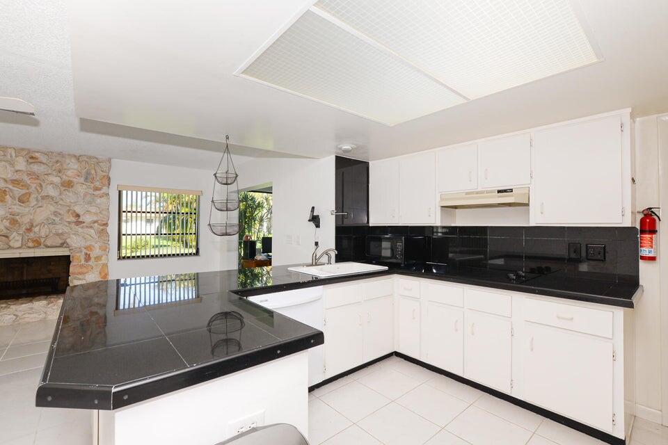 1117 Southeast Mendoza Avenue Port St. Lucie, FL 34952 - Photo 14 of 24 a kitchen with stainless steel appliances a sink and a microwave