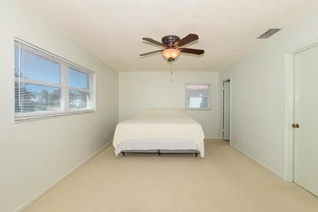 a bedroom with a bed and painting on the wall