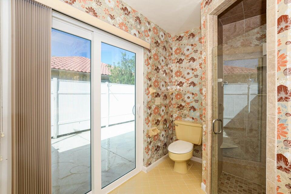 1117 Southeast Mendoza Avenue Port St. Lucie, FL 34952 - Photo 19 of 24 a bathroom with a toilet and a shower