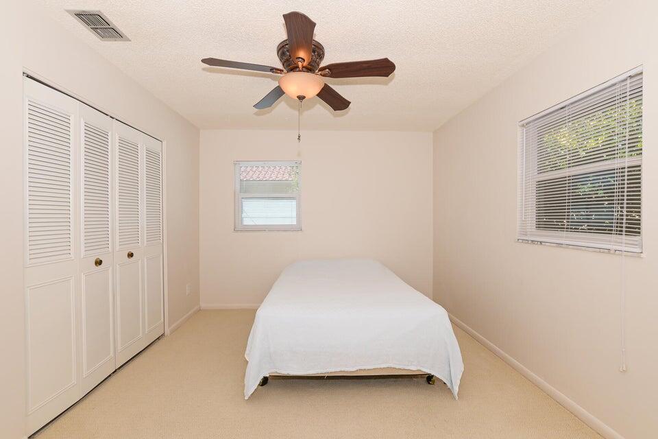 1117 Southeast Mendoza Avenue Port St. Lucie, FL 34952 - Photo 21 of 24 a bedroom with a bed and a window