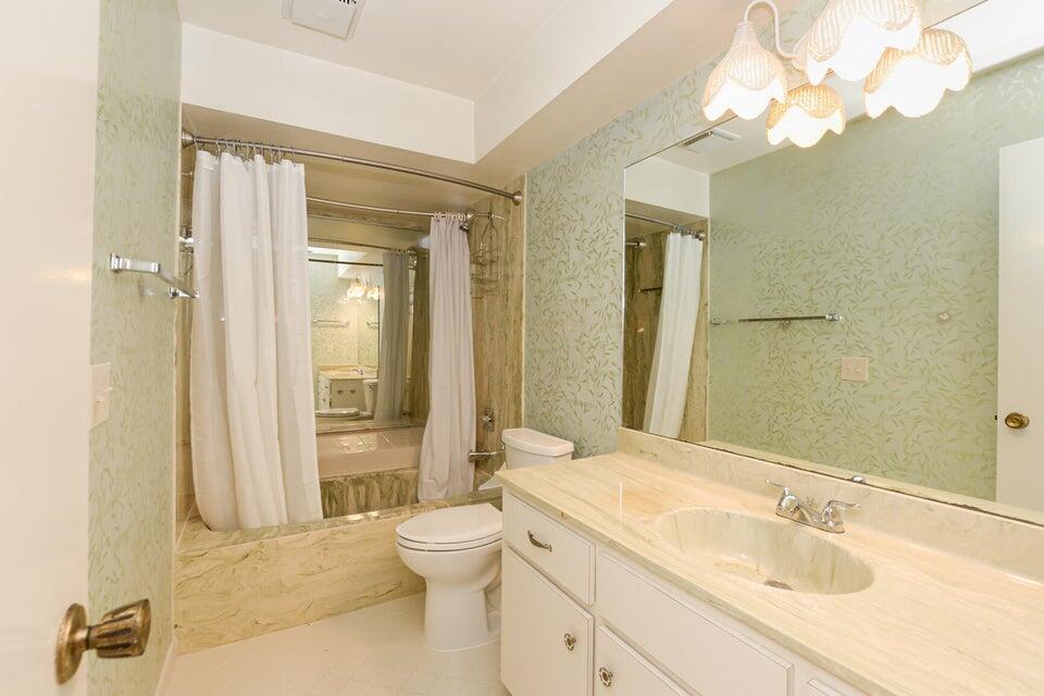 1117 Southeast Mendoza Avenue Port St. Lucie, FL 34952 - Photo 22 of 24 a bathroom with a sink a toilet and shower