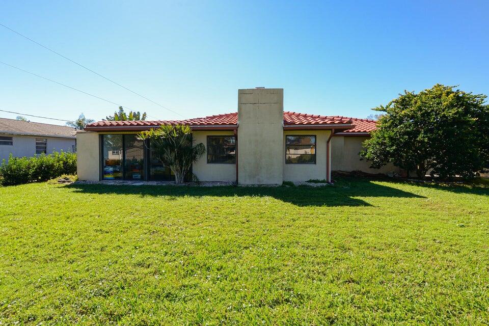 1117 Southeast Mendoza Avenue Port St. Lucie, FL 34952 - Photo 24 of 24 a front view of house with yard and outdoor seating