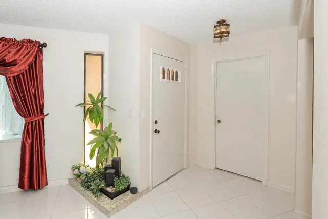 a view of a entryway with flower pots