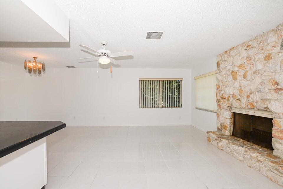 1117 Southeast Mendoza Avenue Port St. Lucie, FL 34952 - Photo 10 of 24 an empty room with windows and fireplace