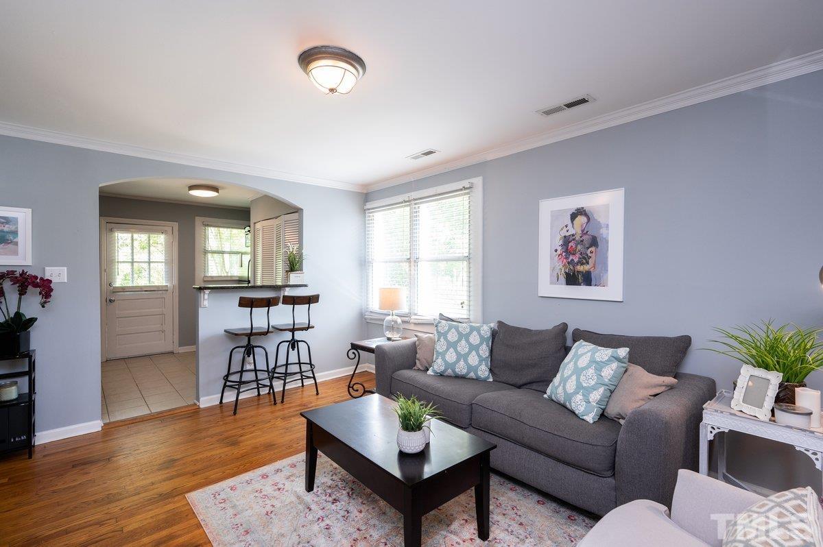 2215 Bernard Street, Unit 2215 Raleigh, NC 27608 - Photo 5 of 16 a living room with furniture and wooden floor