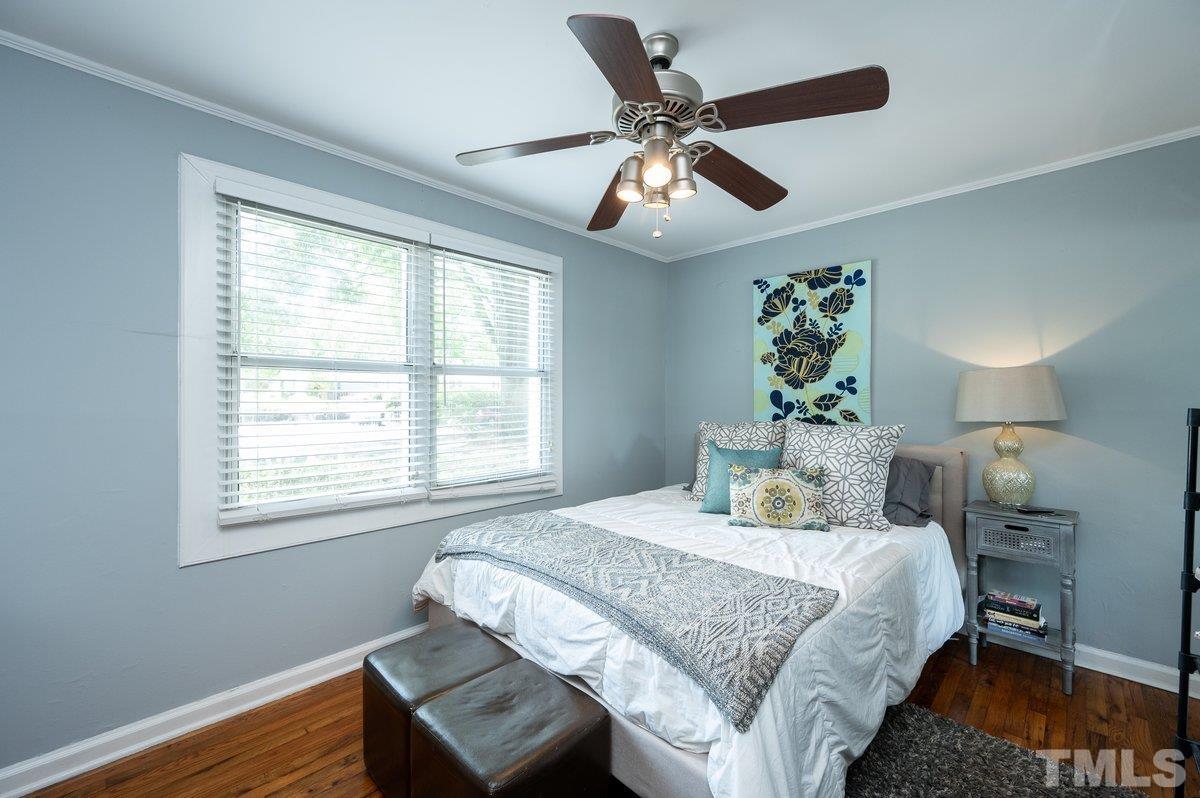 2215 Bernard Street, Unit 2215 Raleigh, NC 27608 - Photo 10 of 16 a bedroom with a large bed and a chandelier