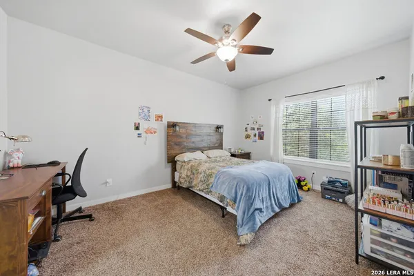 a bed room with a bed window and a flat screen tv