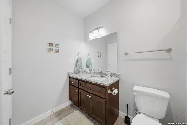 a bathroom with a toilet a sink and a mirror