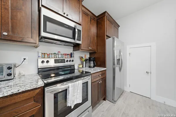 a kitchen with stainless steel appliances granite countertop a stove microwave and sink