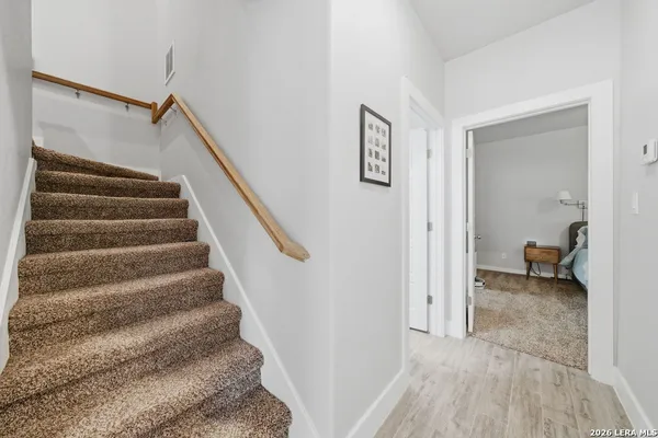 a view of entryway and hall with wooden floor