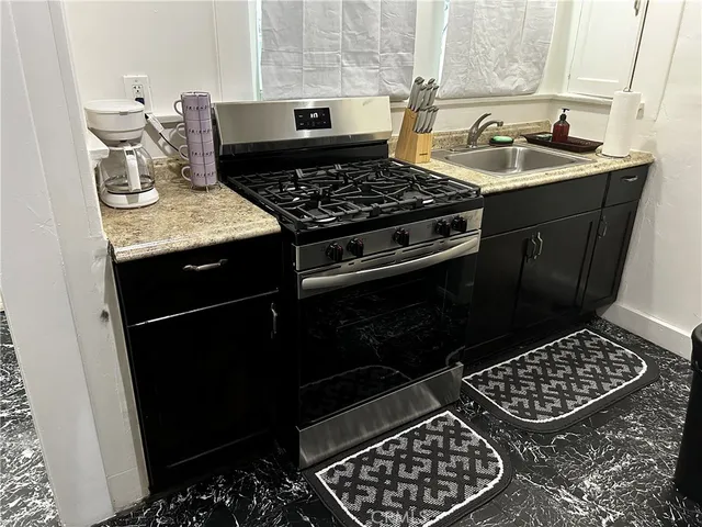 a kitchen with a sink stove and cabinets
