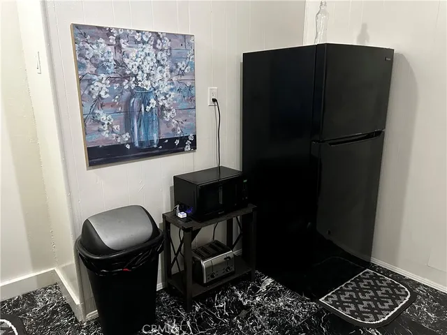 a kitchen with a refrigerator and a stove