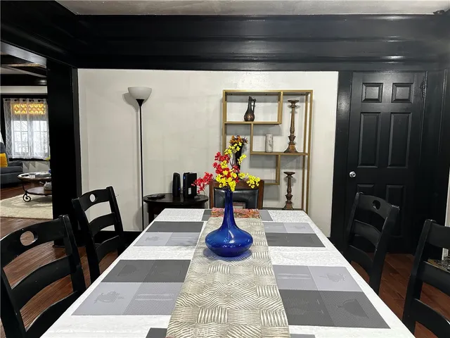 a view of living room with furniture and wooden floor