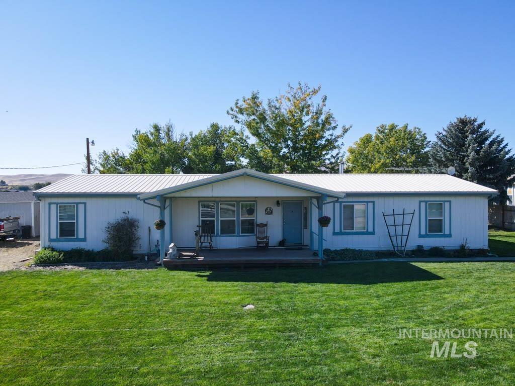815 Eaton Road Weiser, ID 83672 - Photo 1 of 50 Ranch-style home with a front lawn, a porch, and a metal roof