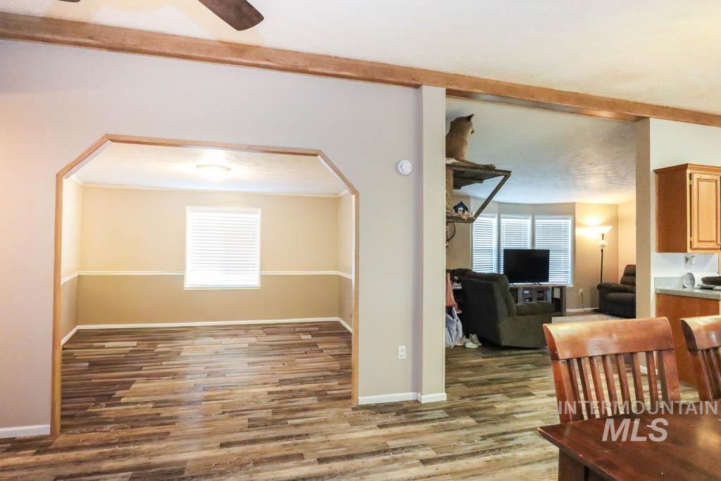 815 Eaton Road Weiser, ID 83672 - Photo 12 of 50 Dining space with arched walkways, light wood-style floors, and a ceiling fan