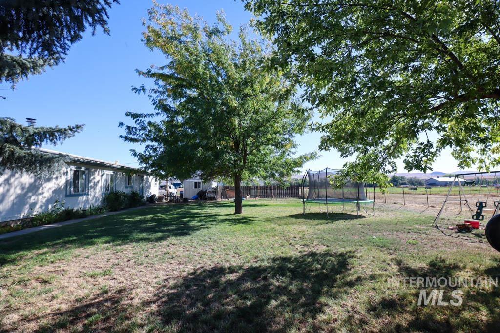 815 Eaton Road Weiser, ID 83672 - Photo 38 of 50 Fenced backyard with a trampoline