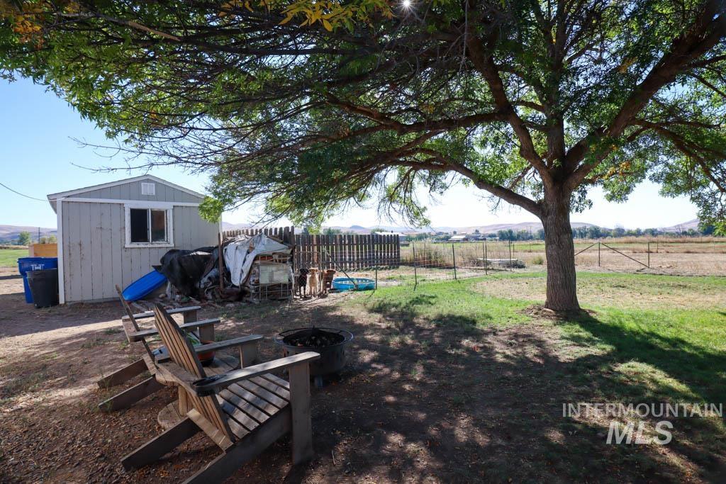 815 Eaton Road Weiser, ID 83672 - Photo 42 of 50 View of yard with a storage shed, a view of countryside, and a fire pit