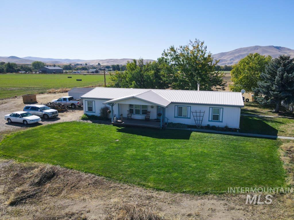 815 Eaton Road Weiser, ID 83672 - Photo 45 of 50 Single story home featuring a front yard, a mountain view, a porch, and a view of rural / pastoral area