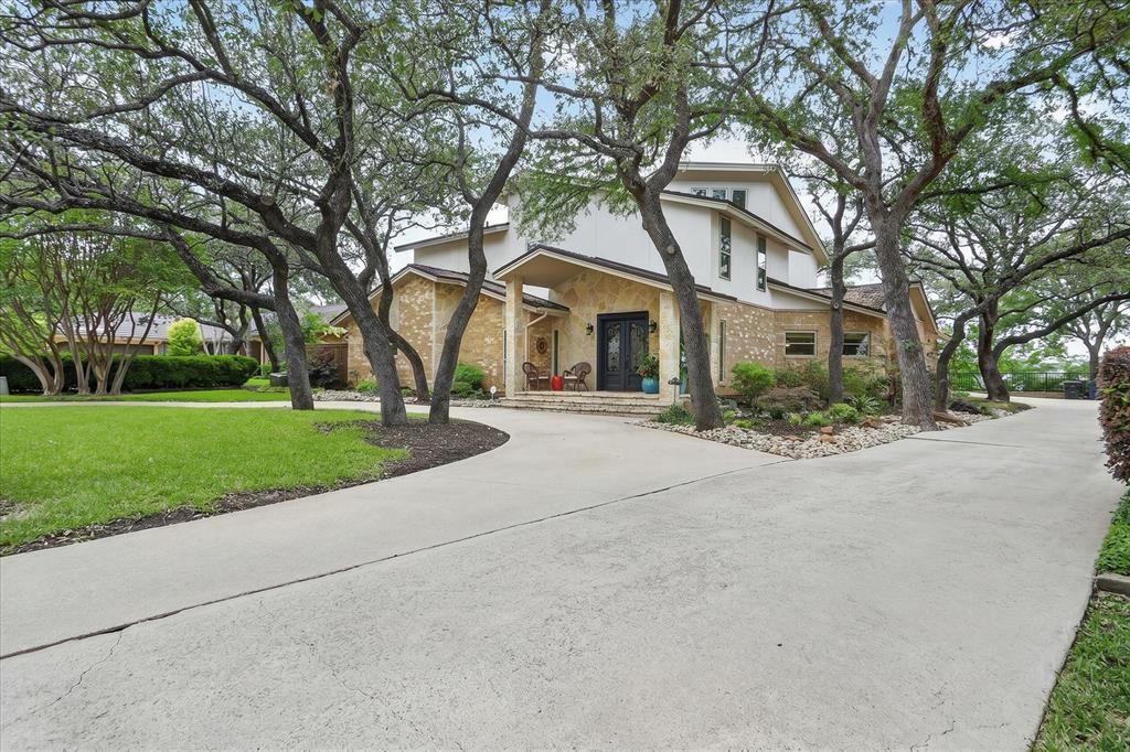 8877 Random Road Fort Worth, TX 76179 - Photo 3 of 40 Expansive concrete driveway leading to a two-story residence with stone and stucco exterior