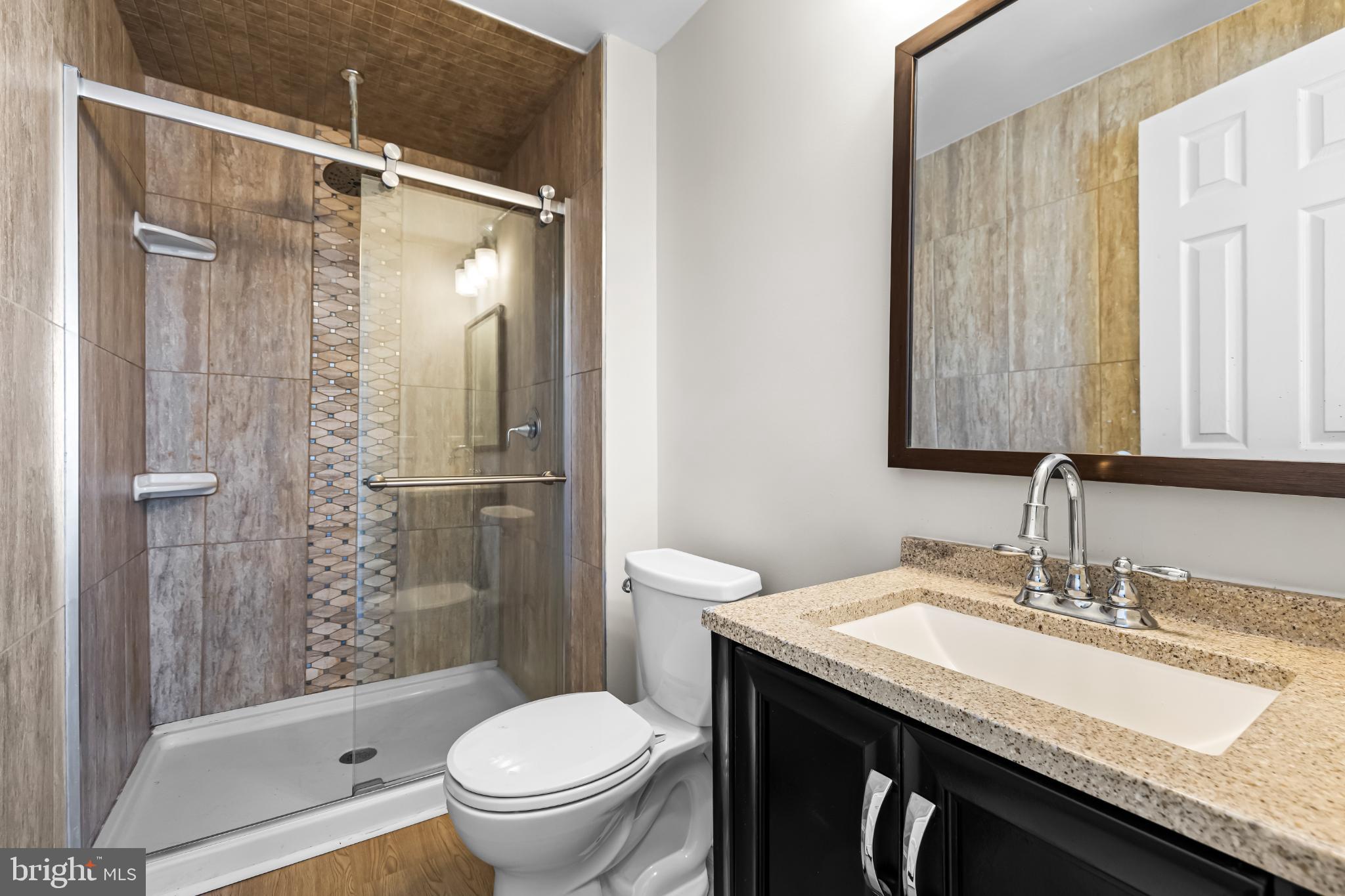 925 Pirates Court Edgewood, MD 21040 - Photo 13 of 29 a bathroom with a granite countertop sink toilet and shower glass cabinet