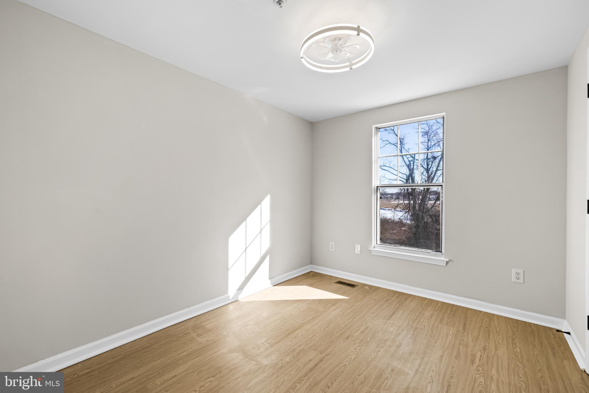925 Pirates Court Edgewood, MD 21040 - Photo 18 of 29 an empty room with wooden floor and windows