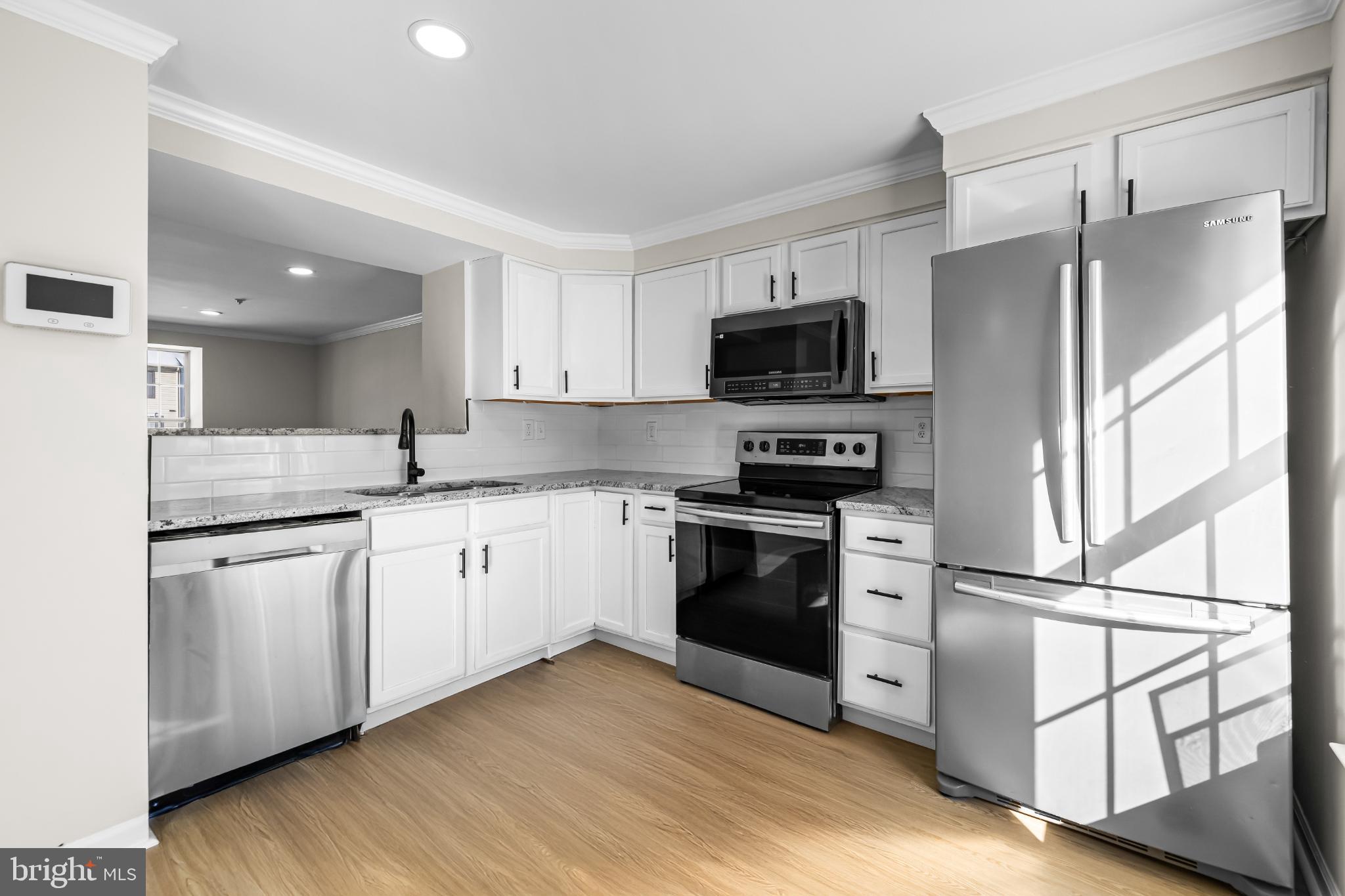 925 Pirates Court Edgewood, MD 21040 - Photo 7 of 29 a kitchen with cabinets stainless steel appliances and wooden floor