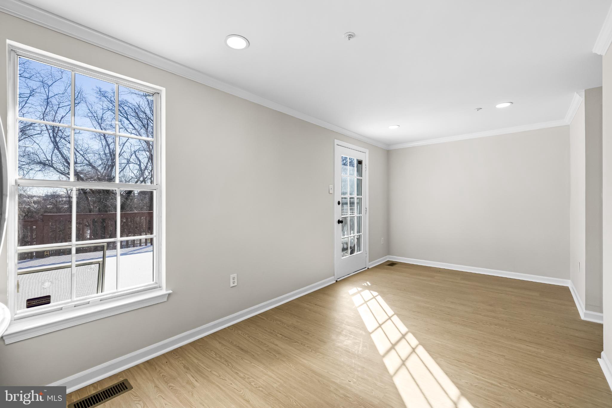 925 Pirates Court Edgewood, MD 21040 - Photo 9 of 29 an empty room with wooden floor and windows