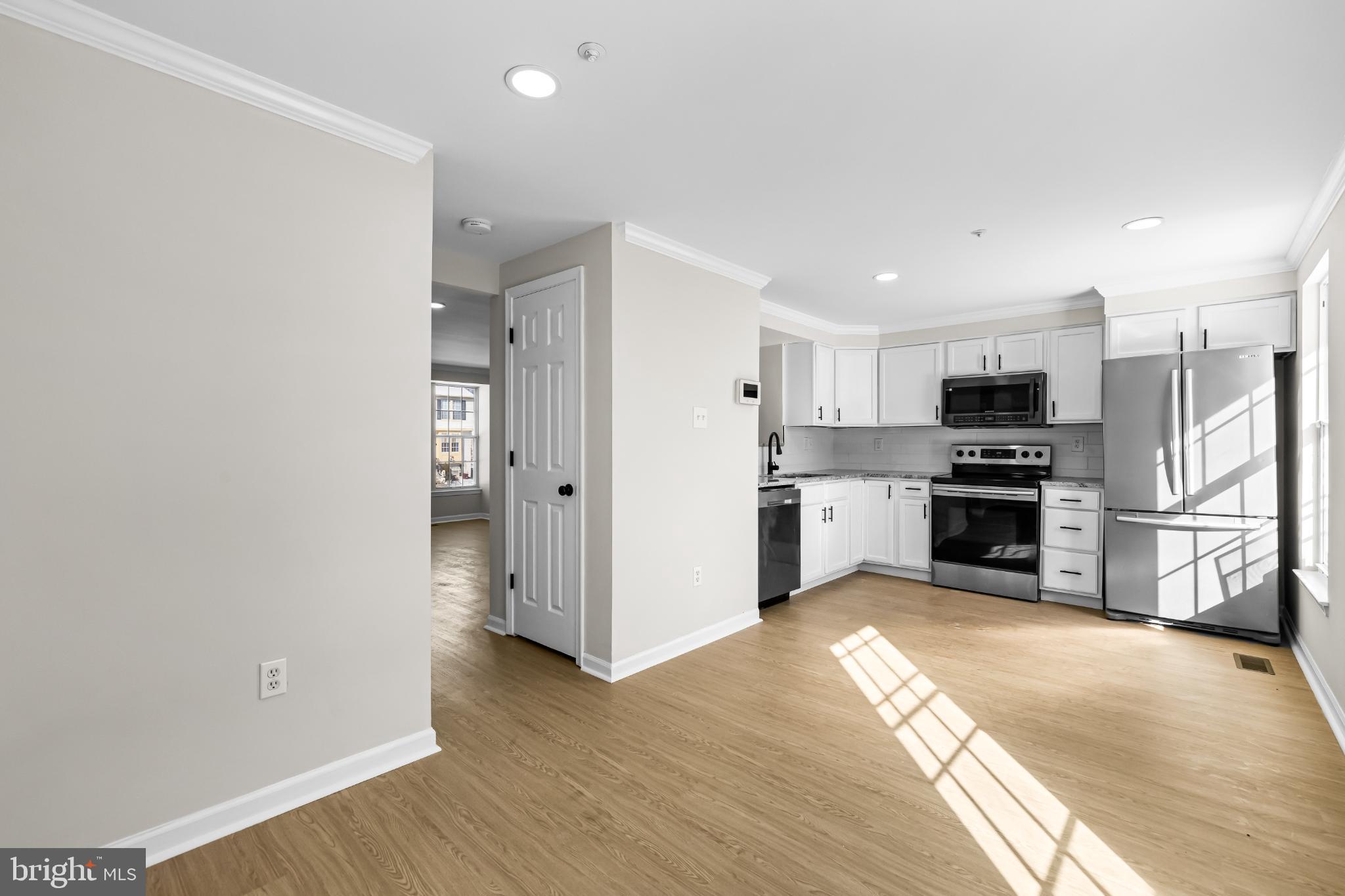925 Pirates Court Edgewood, MD 21040 - Photo 10 of 29 a kitchen with a refrigerator and a stove top oven