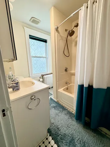 a bathroom with a tub sink and shower