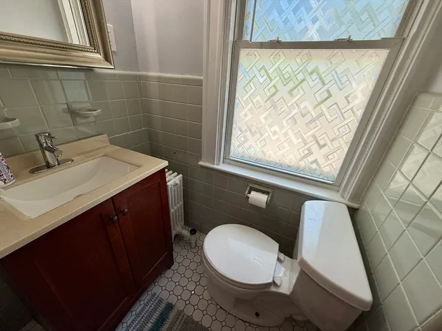 a bathroom with a sink a toilet and a mirror