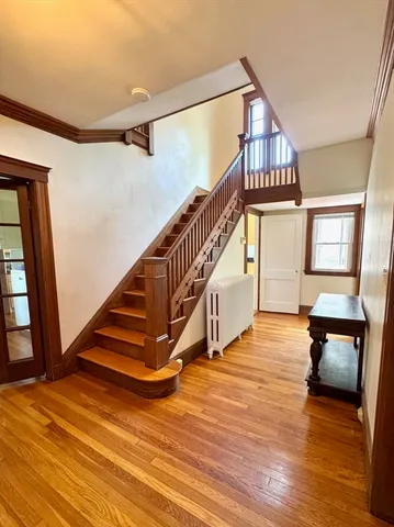a view of entryway and hall with wooden floor