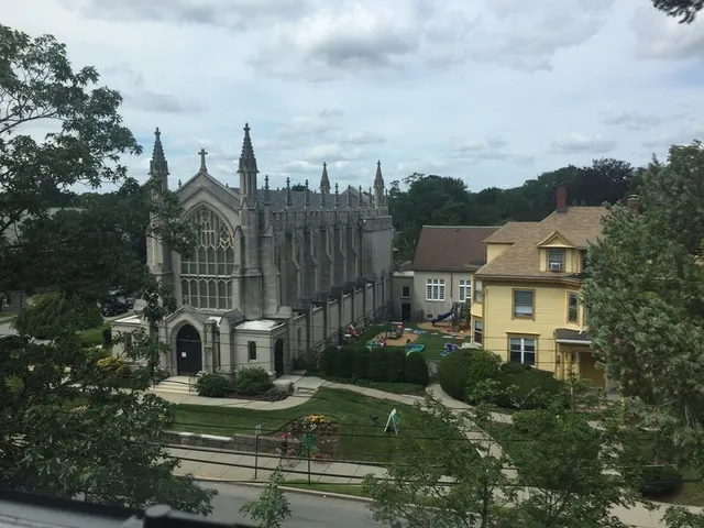 a view of a city with tall buildings and a big yard