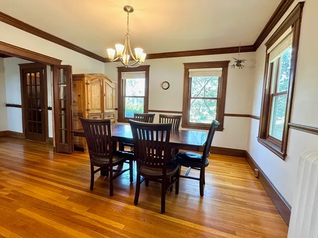 a view of a dining room with furniture window and wooden floor
