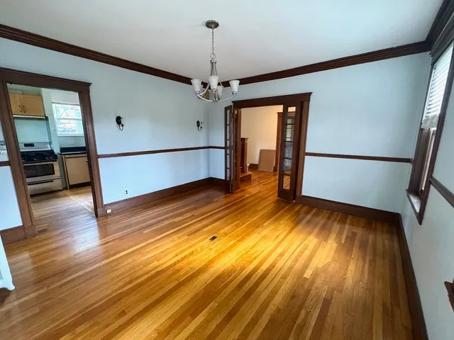 a view of a room with wooden floor and stairs