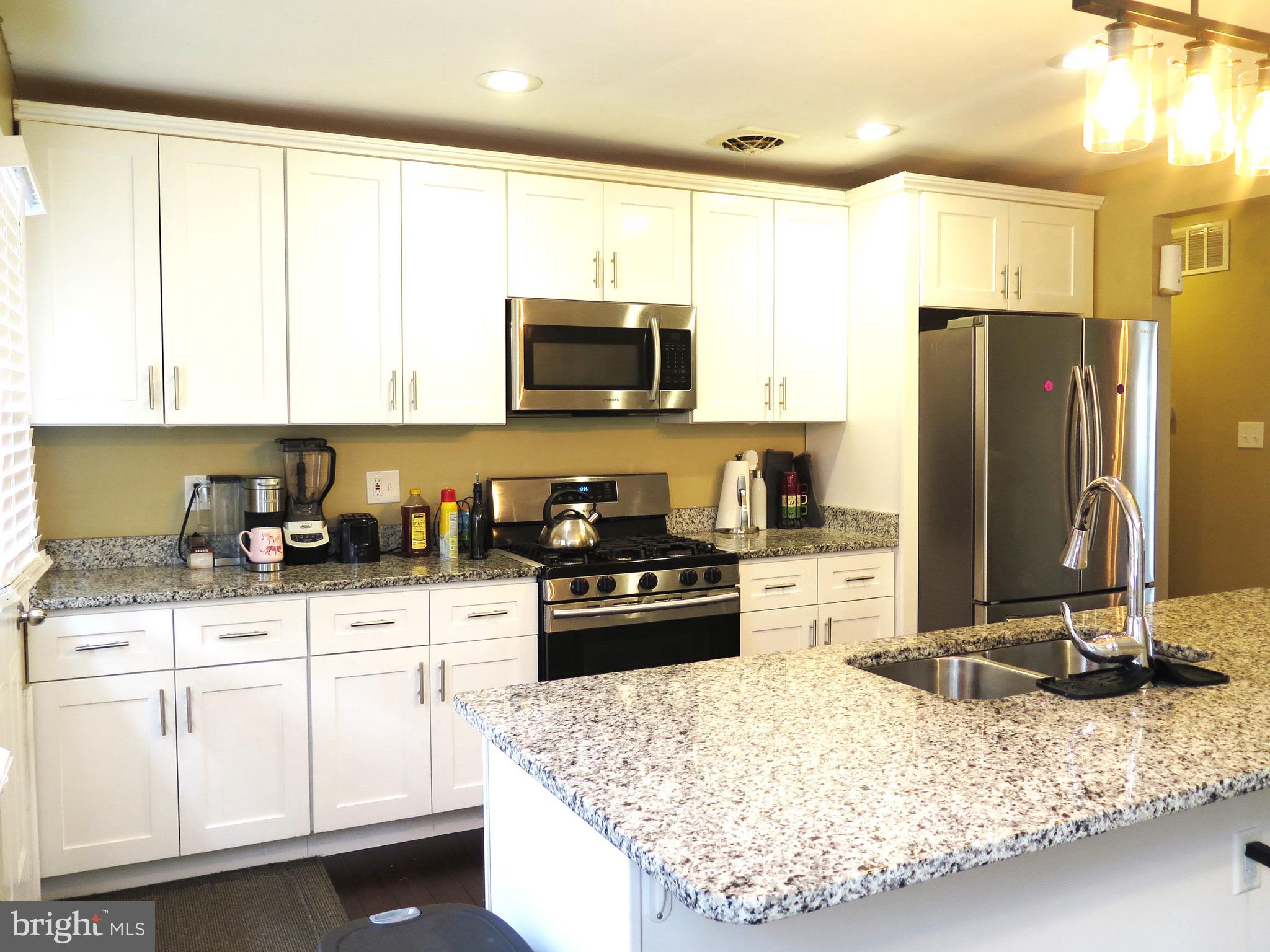 3939 Nemo Road Randallstown, MD 21133 - Photo 2 of 31 a kitchen with granite countertop a refrigerator sink and stove