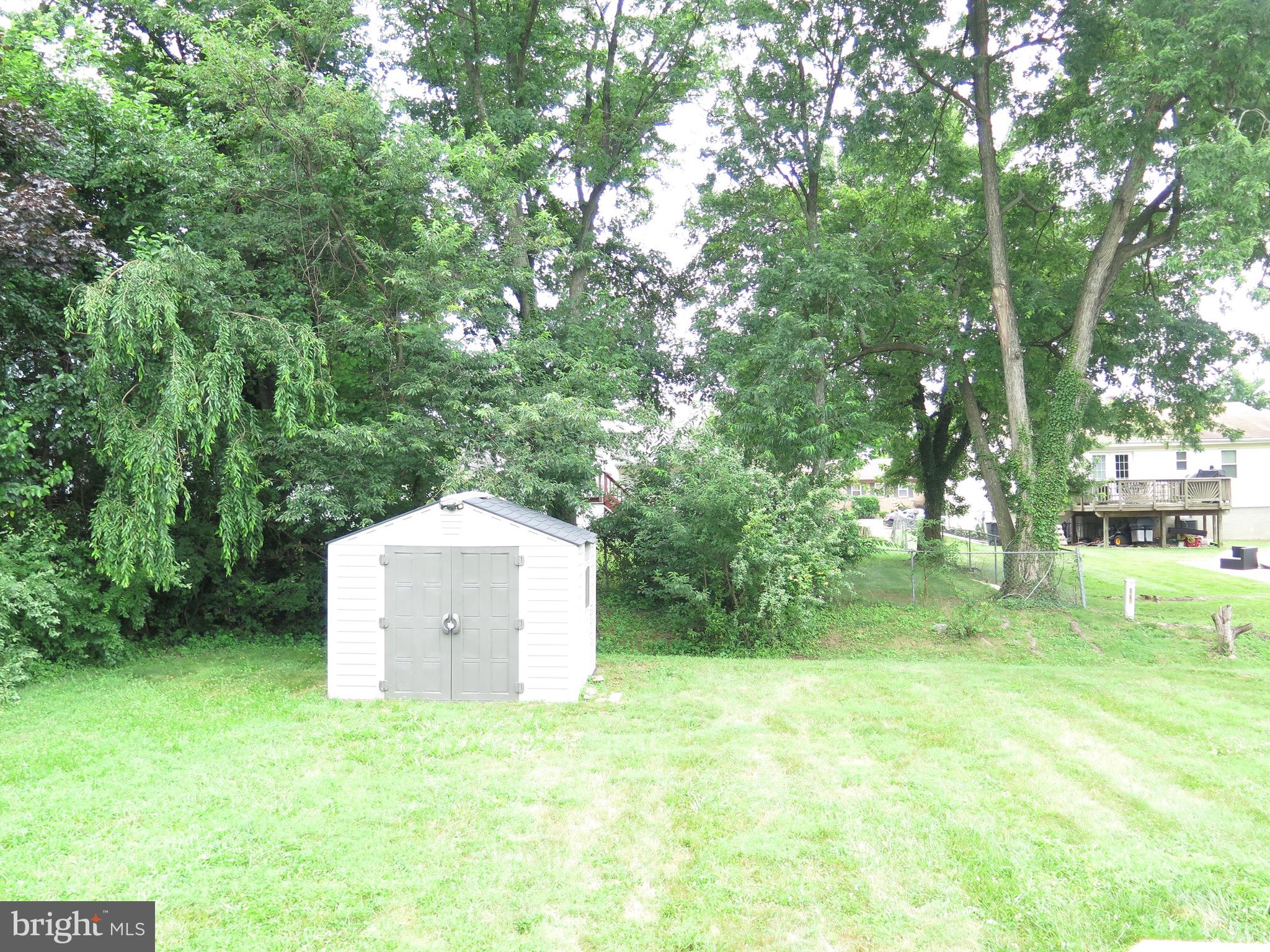 3939 Nemo Road Randallstown, MD 21133 - Photo 27 of 31 a backyard of a house with trees and stairs
