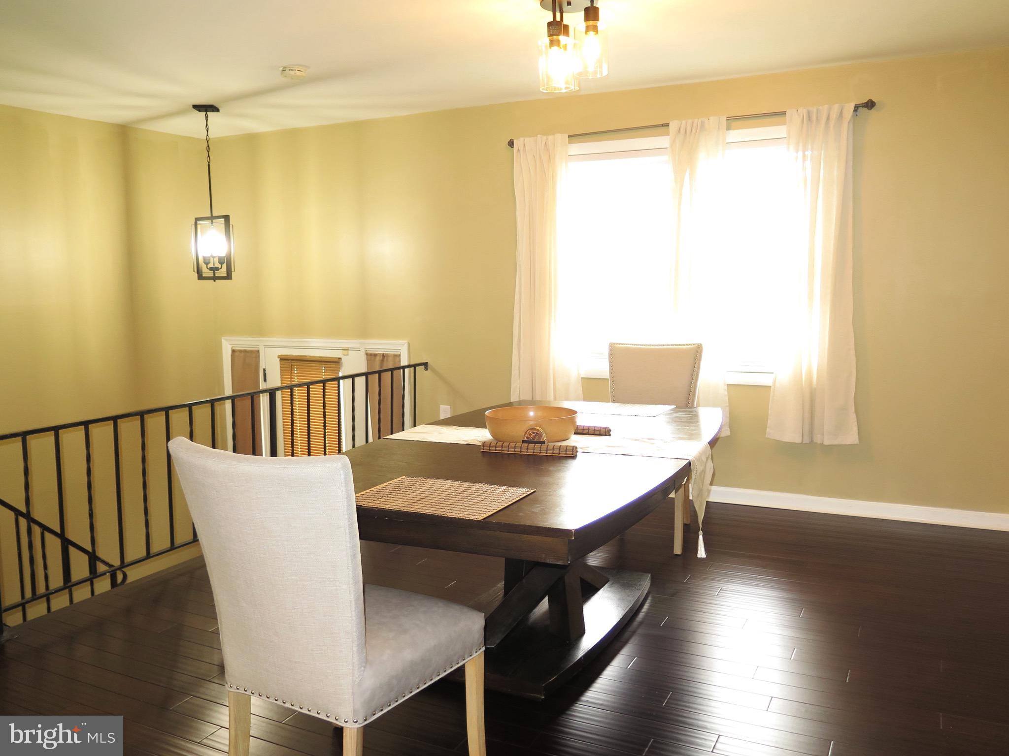 3939 Nemo Road Randallstown, MD 21133 - Photo 8 of 31 a view of a dining room with furniture and wooden floor