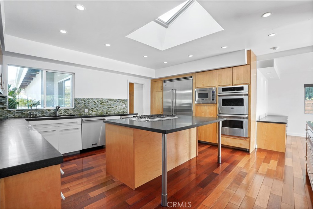 16301 Meadow Ridge Road West Encino, CA 91436 - Photo 15 of 33 a kitchen with stainless steel appliances granite countertop a stove and a wooden floors