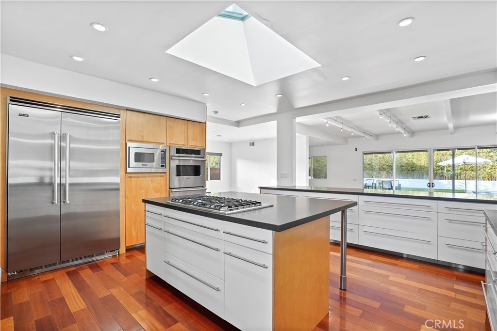 16301 Meadow Ridge Road West Encino, CA 91436 - Photo 16 of 33 a kitchen with stainless steel appliances granite countertop a stove and a refrigerator