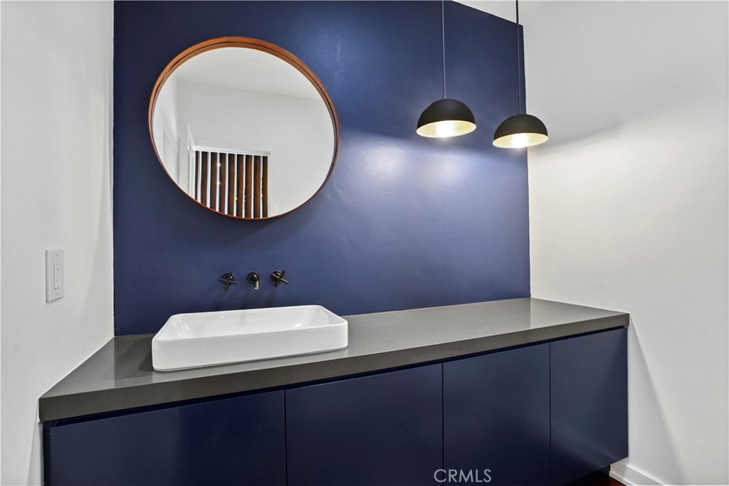 16301 Meadow Ridge Road West Encino, CA 91436 - Photo 19 of 33 a bathroom with a sink and a mirror