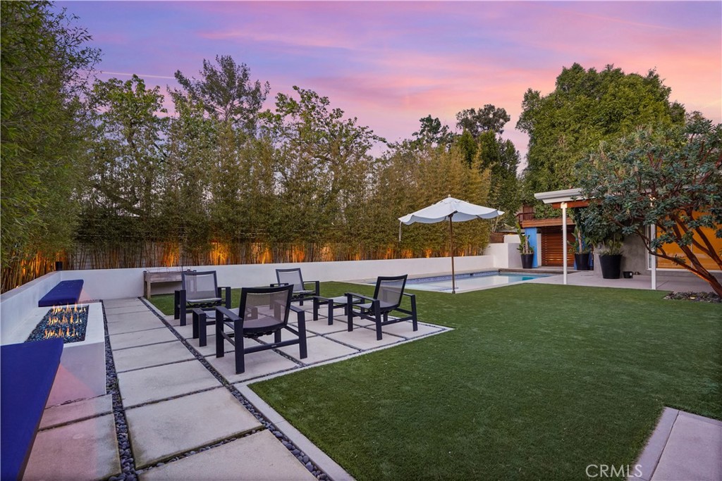 16301 Meadow Ridge Road West Encino, CA 91436 - Photo 2 of 33 a view of a patio with table and chairs under an umbrella