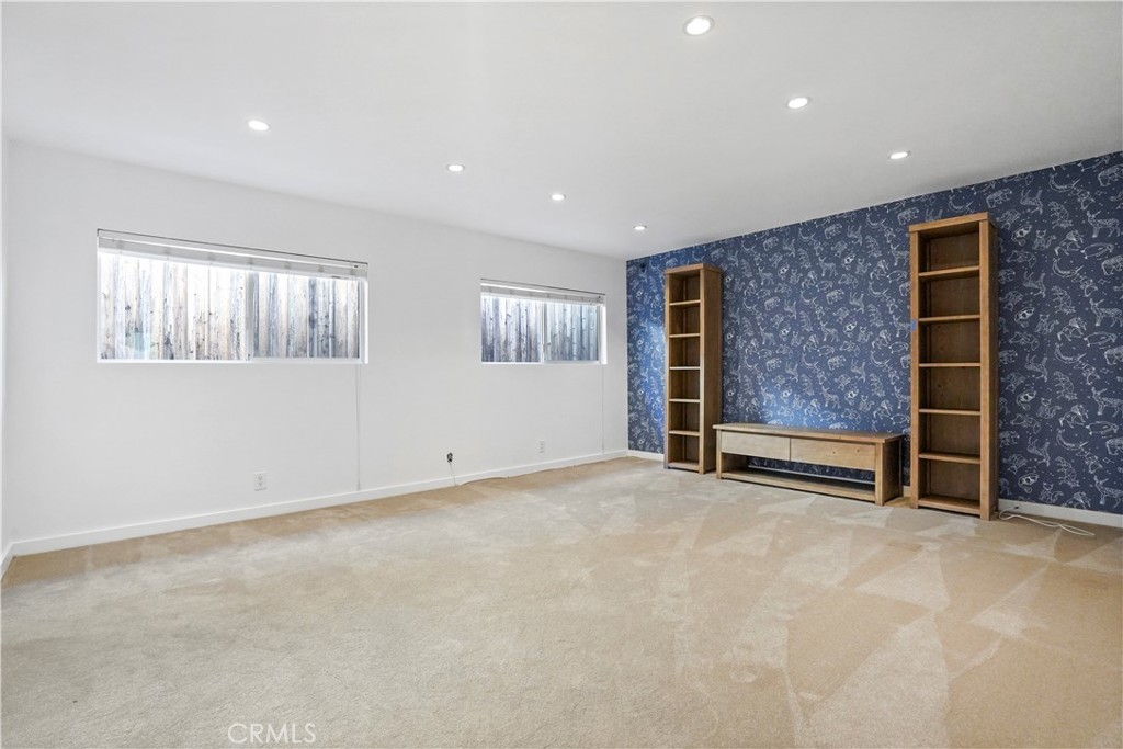 16301 Meadow Ridge Road West Encino, CA 91436 - Photo 23 of 33 a view of an empty room with a fireplace