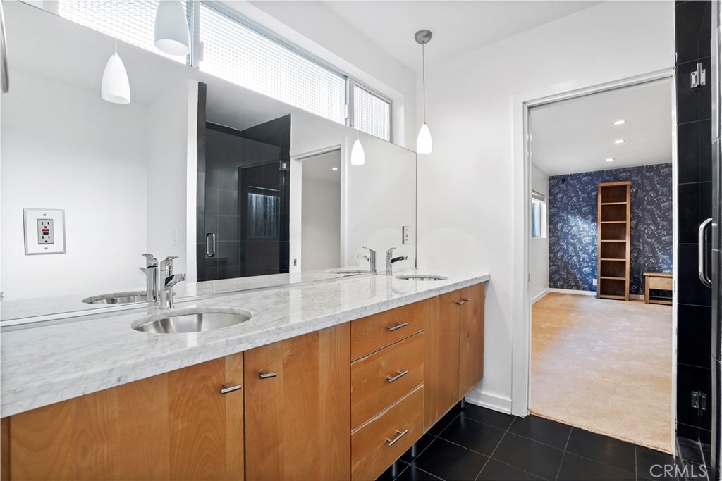 16301 Meadow Ridge Road West Encino, CA 91436 - Photo 26 of 33 a bathroom with a sink double vanity granite tub shower and a mirror