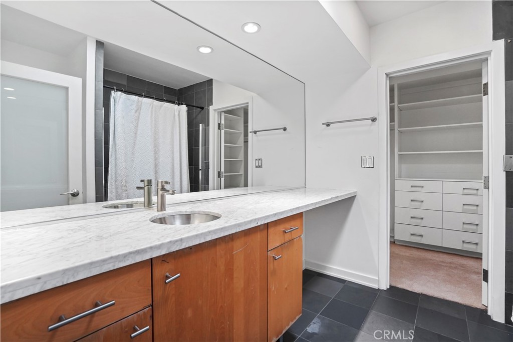 16301 Meadow Ridge Road West Encino, CA 91436 - Photo 29 of 33 a bathroom with a sink a mirror and a shower